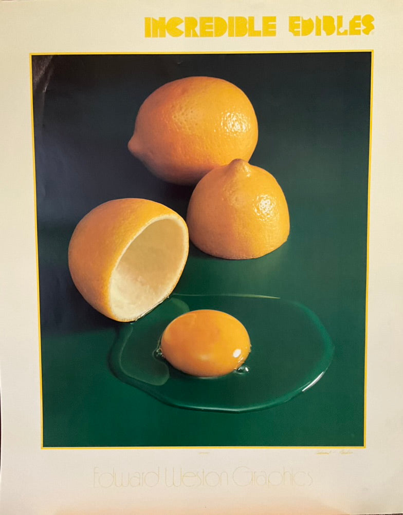 A photo of lemons, one split in half and carved out to make it appear as though an uncooked egg is coming out of it. Primarily yellow and green.