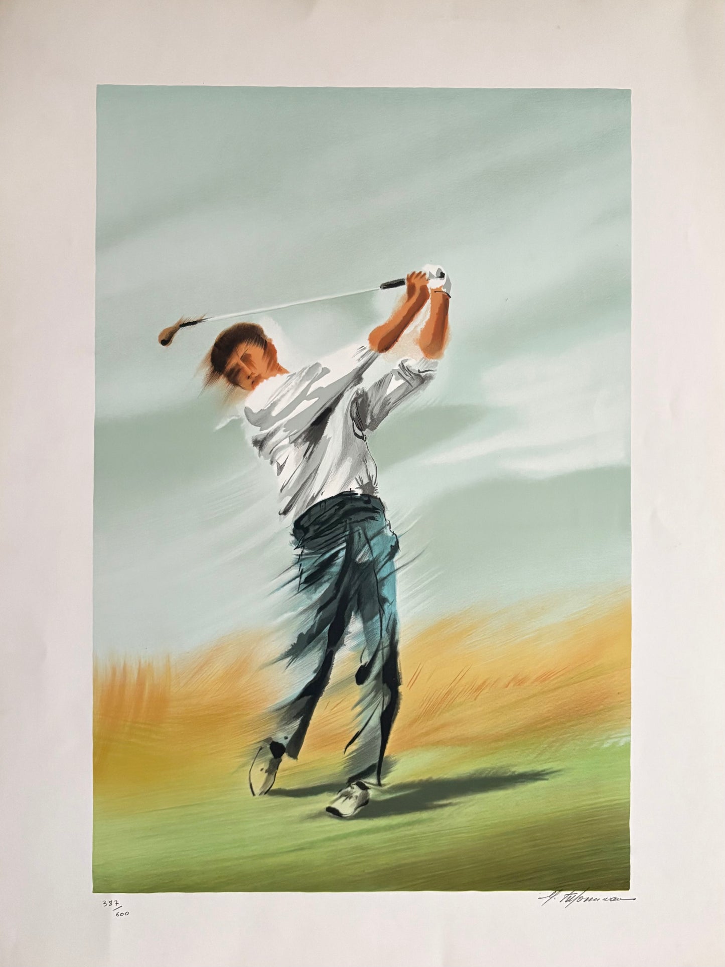Unframed lithograph of a golfer in mid-swing on a golf course, signed by the artist Maurice Filonneau. Primary color palette is green, yellow and blue.