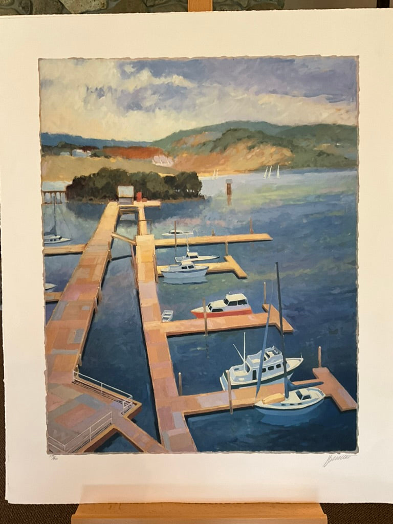 Max Hayslette “Boat Dock” limited-edition print showing sailboats and yachts moored at a wooden dock on a calm blue lake with hills in the background and a partly cloudy sky. Peaceful coastal landscape artwork, signed and numbered, 30" x 37" unframed.