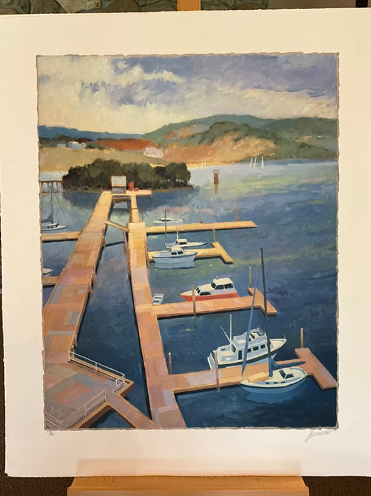 Max Hayslette “Boat Dock” limited-edition print showing sailboats and yachts moored at a wooden dock on a calm blue lake with hills in the background and a partly cloudy sky. Peaceful coastal landscape artwork, signed and numbered, 30" x 37" unframed.