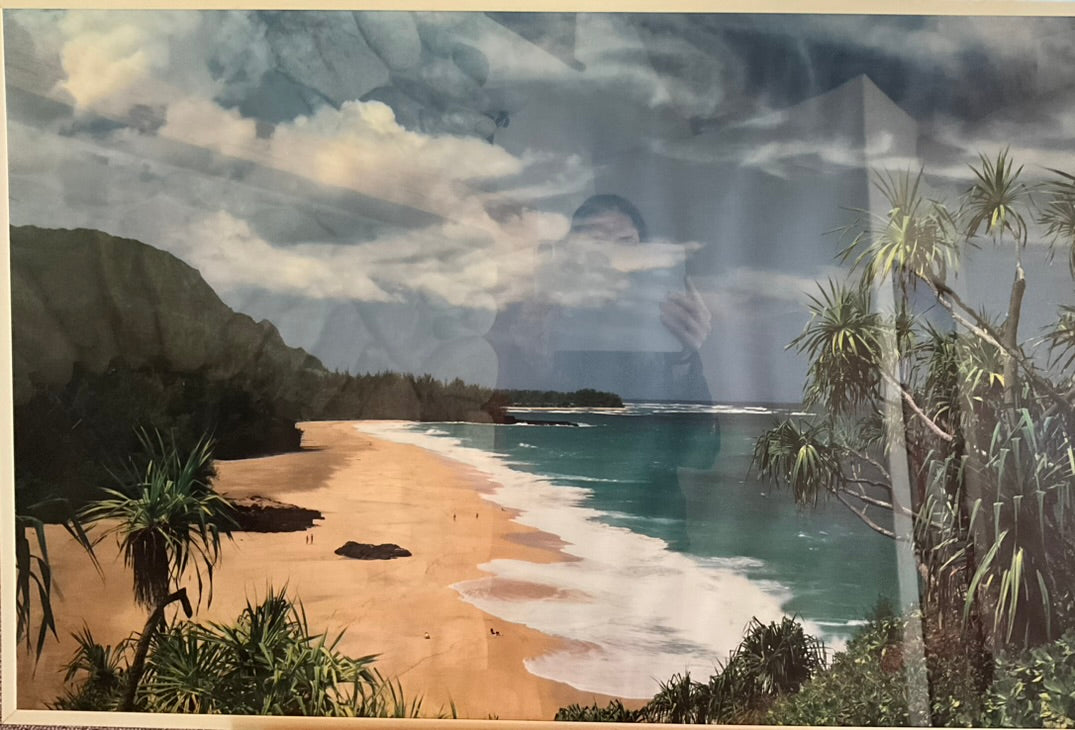 A photograph of a scenic view of a tropical beach, fully equipped with palm trees, serene blue water. and storm clouds accumulating above.