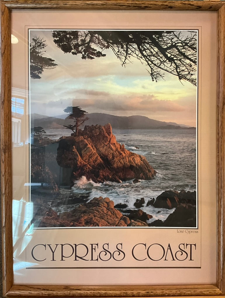 A photograph of the lone cypress tree on a rocky shore in central California with a beautiful muted sunset. Underneath the photo reads: CYPRESS COAST in a decorative font.