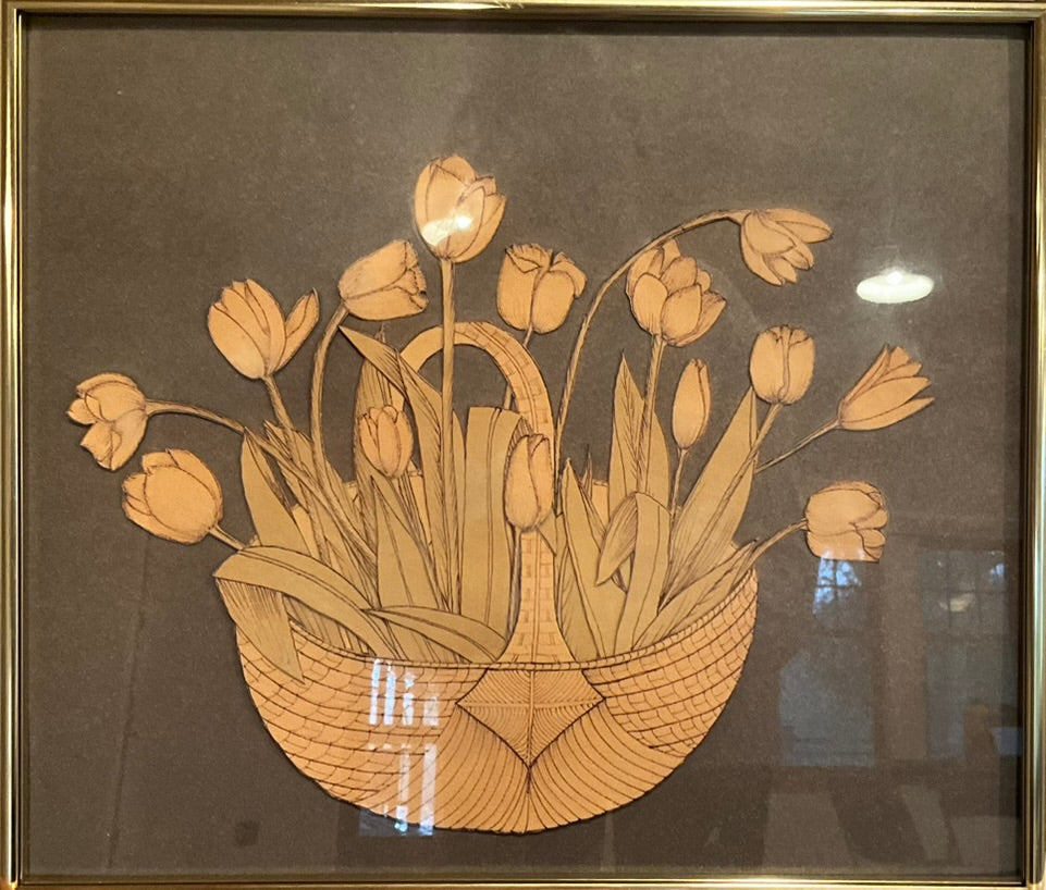 Framed artwork depicting a basket of flowers, with a beige frame.